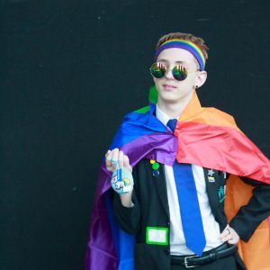 young person dressed in pride cape