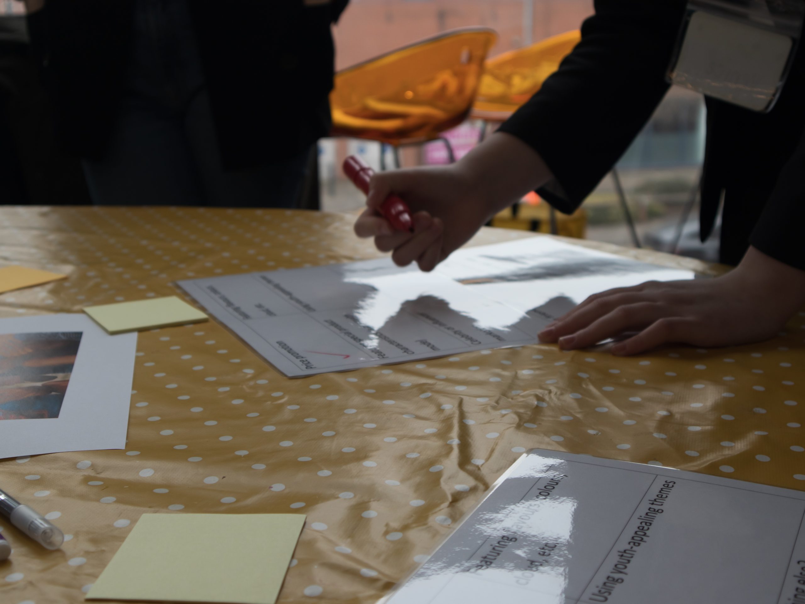 Photo of somebody's hand writing on a table