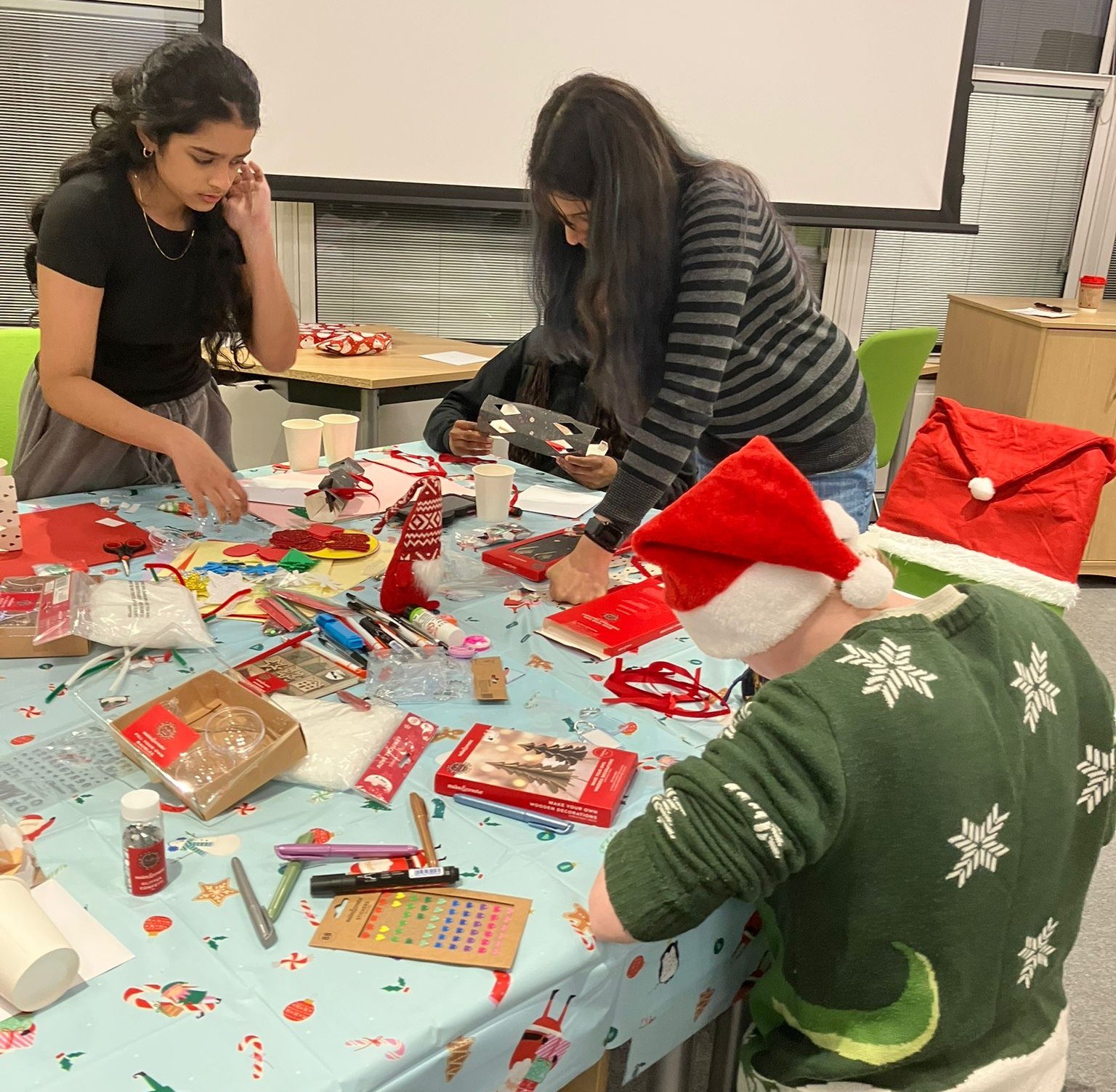 Picture of three young people doing Christmas crafts